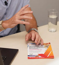 hands showing flyer on desk